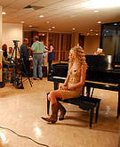 Taylor Swift posing by piano